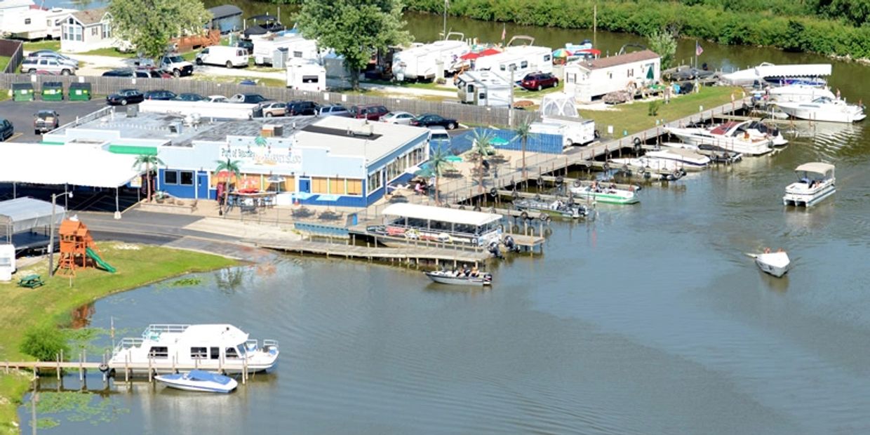 A marina with boats docked and a building nearby.