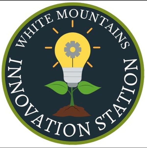 Logo of White Mountains Innovation Station with lightbulb and plant.