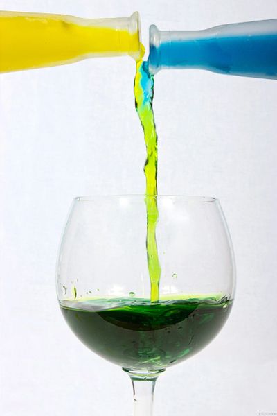 Colored liquids mixing in a wine glass