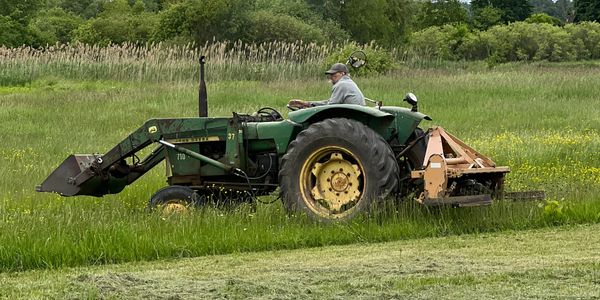 Farmer driving john deere 710 tractor