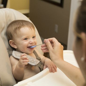 Child during home pediatric feeding therapy session in Phoenix, AZ to improve eating skills.