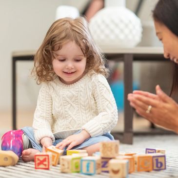 child working on fine motor skills occupational therapist in a home therapy session in Phoenix AZ