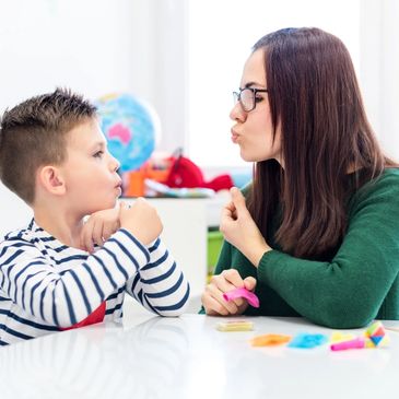 Child practicing speech with therapist during in-home pediatric speech therapy session Phoenix