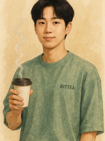 Young man in green shirt holding a steaming cup of coffee.