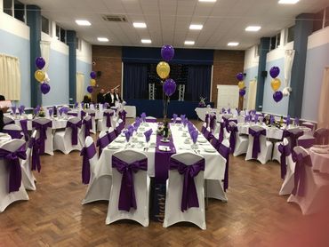 Purple sashes and tablecloths with flower centres 