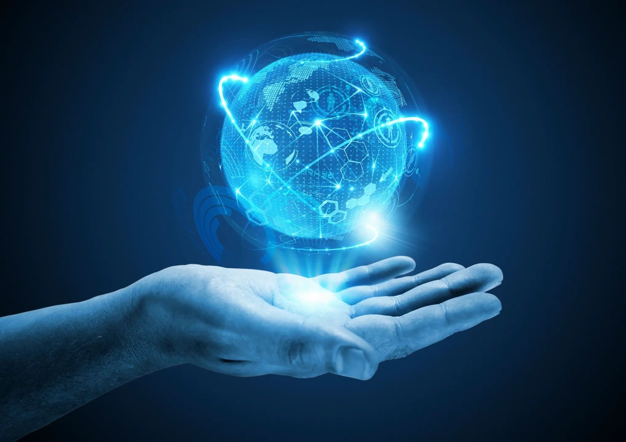 Hand holding a glowing digital globe with data connections.