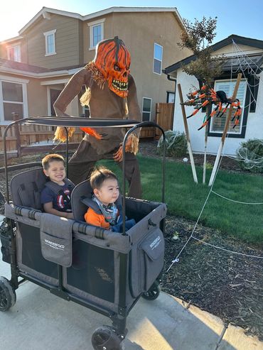 two small children in a wagon out for walk