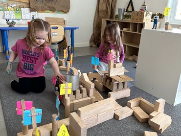 two small girls playing with blocks