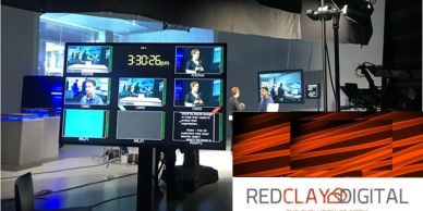 News studio with monitors and REDCLAY DIGITAL logo.
