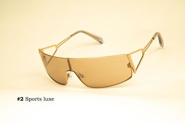 Stylish gold-framed sports luxe sunglasses with brown lenses.