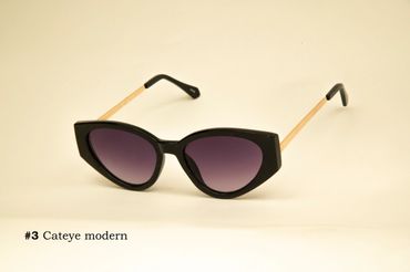Modern cat-eye sunglasses with black frames and gold temples.