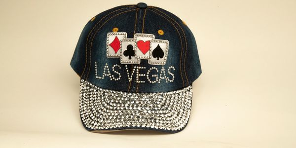 Decorative Las Vegas cap with playing card symbols and rhinestones.
