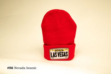 Red beanie with Nevada Las Vegas patch on white background.
