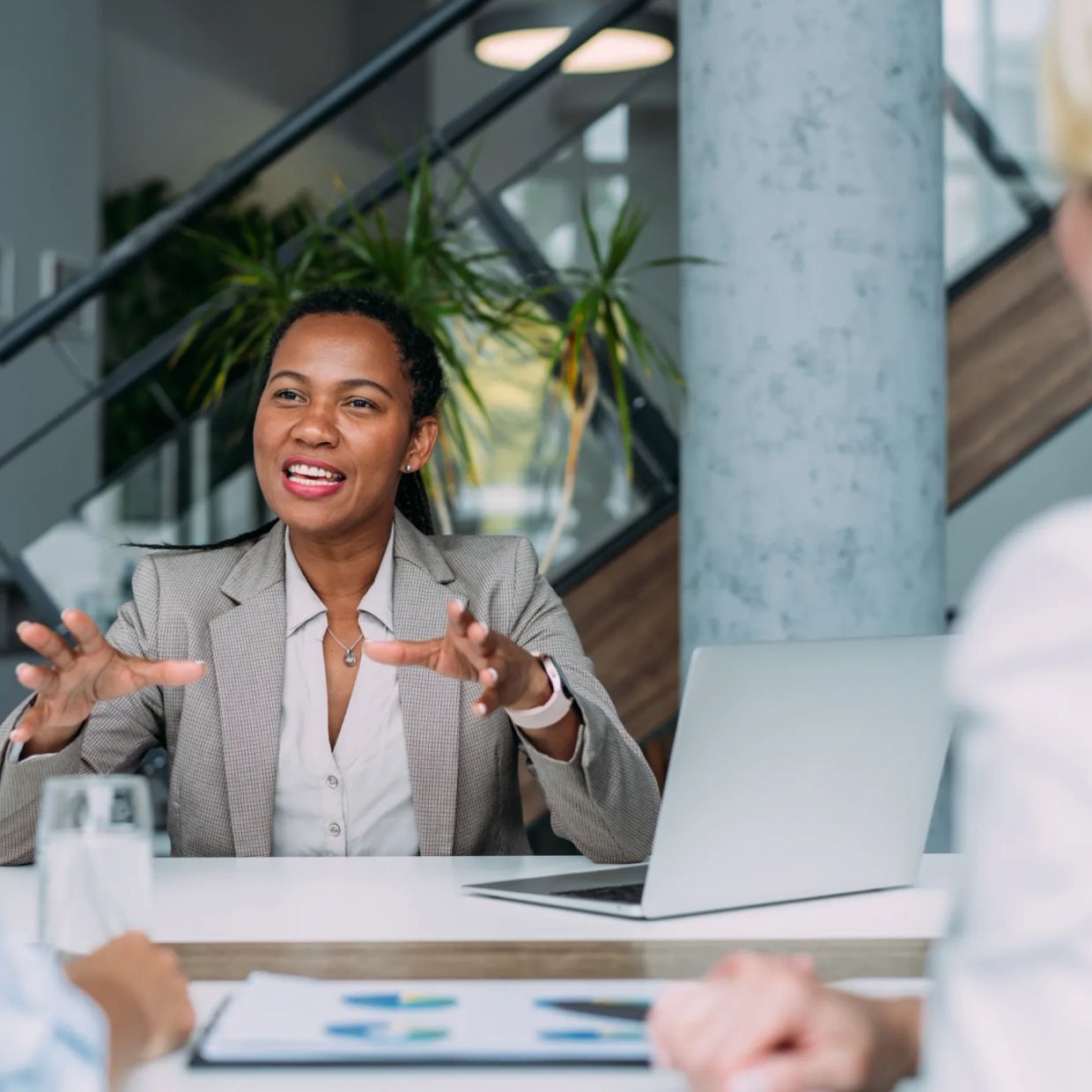 Professional woman explaining something in a business meeting.