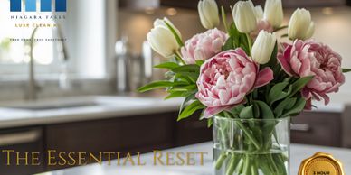Elegant bouquet of pink peonies and white tulips on a kitchen counter.