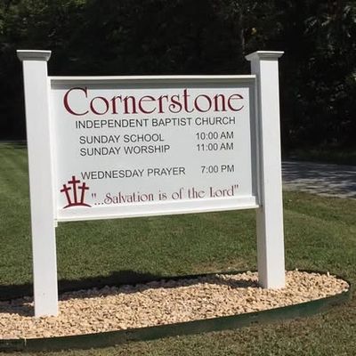 Signboard for Cornerstone Independent Baptist Church with service times and a religious message.