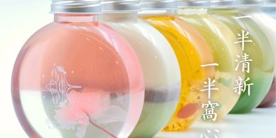 Colorful layered drinks in round bottles with Chinese text beside them.
