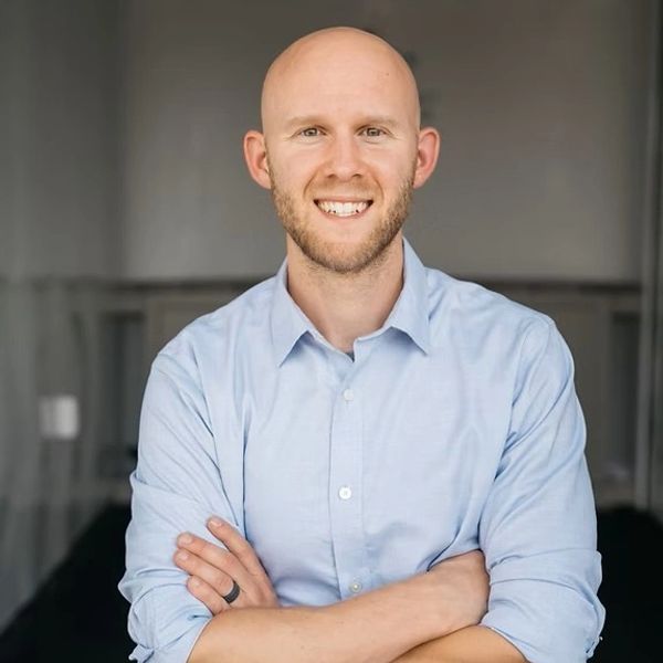 male in white room with blue shirt