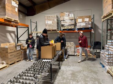 People packing boxes in a warehouse.