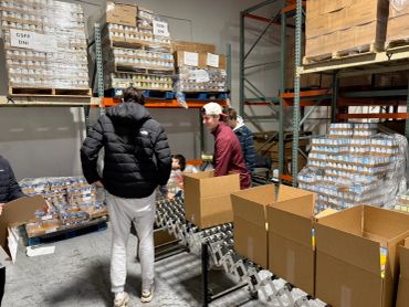 People packing boxes in a warehouse.