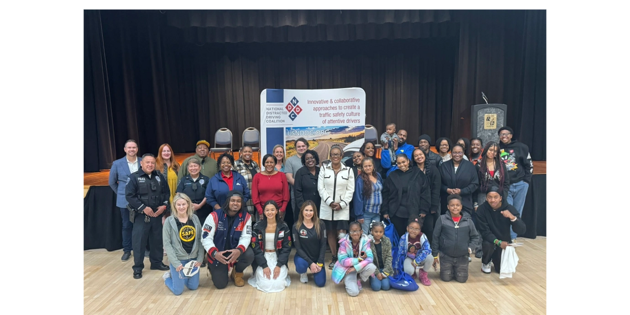 A large group of attendees at the community event smiling