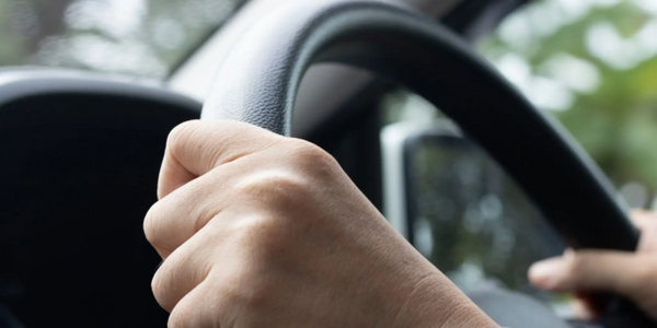 two hands on the steering wheel driving safely