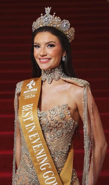 Beauty queen wearing a crown and sash for Best in Evening Gown 2026.