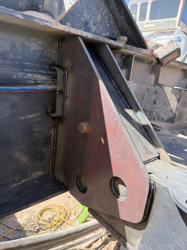 Close-up of a metal bracket bolted to a steel structure.