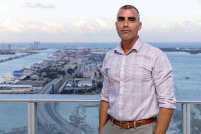 William Padula,  Miami Beach Real Estate 305 agent standing on a balcony overlooking Downton Miami