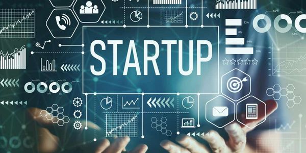 Futuristic digital interface highlighting the word 'STARTUP' with various business graphs and icons.