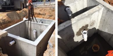 Concrete septic tank installation with plumbing connections.