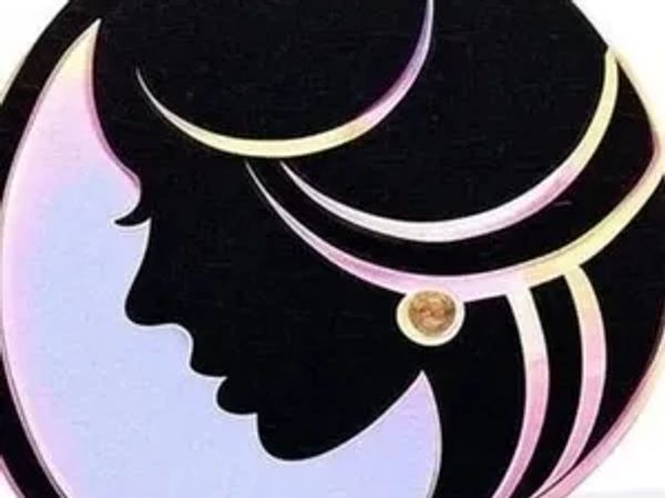 Artistic silhouette of a woman's profile with flowing hair and a crescent moon.