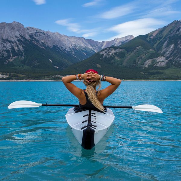 Woman sailing in a kayakl on a lake