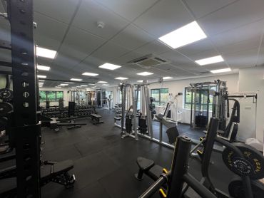 Spacious gym with various workout equipment.