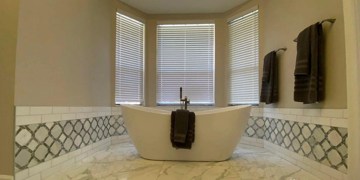A standing tub on the porcelain tiles floor