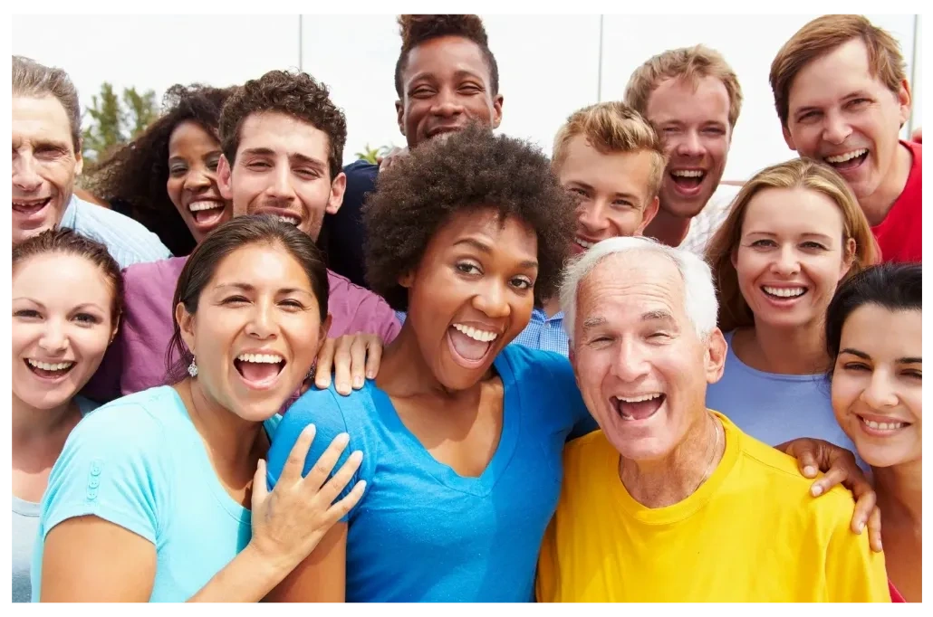 Group of diverse people in ethnicity and age smiling for the camera.