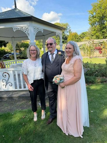 Whanganui Wedding Celebrant Prue after officiating a wedding, standing with the happy couple