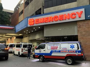 Ambulances parked outside an emergency hospital entrance.