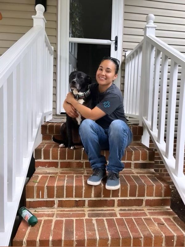 Megan holding a dog. 