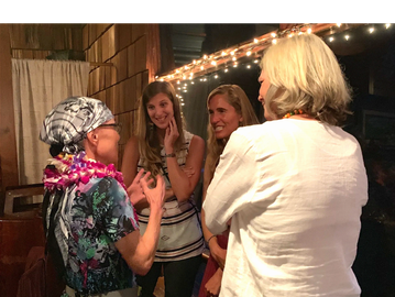 Four women engaged in a lively conversation.