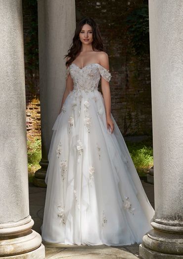 Elegant off-shoulder white wedding dress with floral appliques.