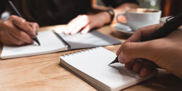 hand holding a pen to paper
