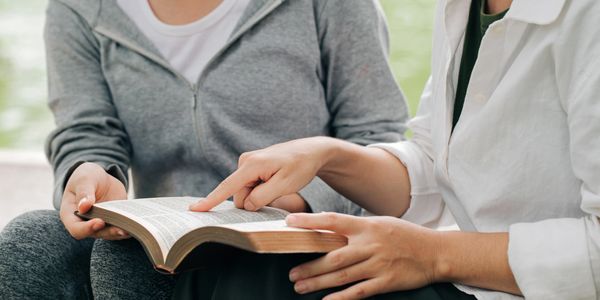 two people with a book