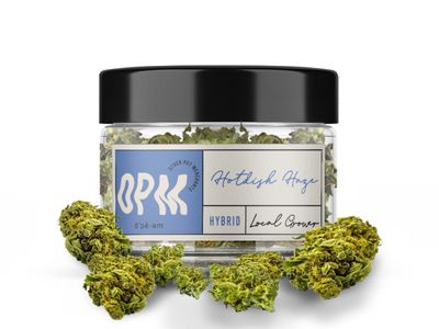 Container of BRK Hotlight Haze hybrid cannabis with buds around it.