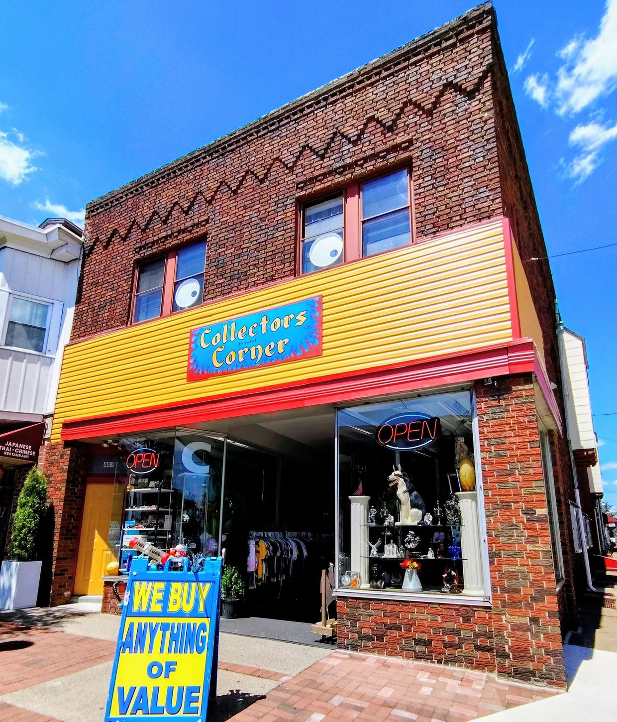 Collectors Corner shop with colorful signage and a bright blue and yellow sign outside.