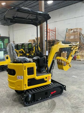 Compact yellow mini excavator indoors.