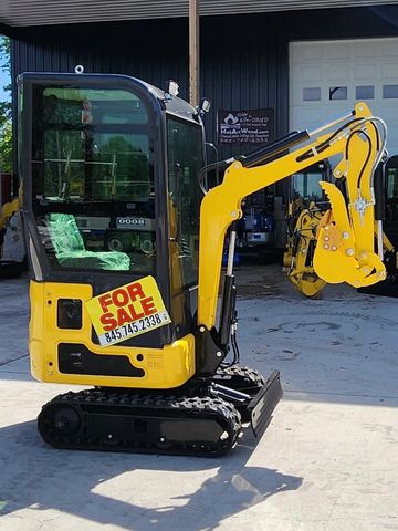 Yellow mini excavator with a For Sale sign.