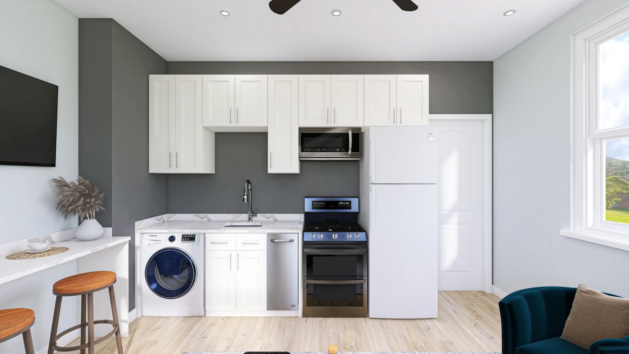 Modern kitchenette with white cabinets, stainless steel appliances, and a dark accent wall.