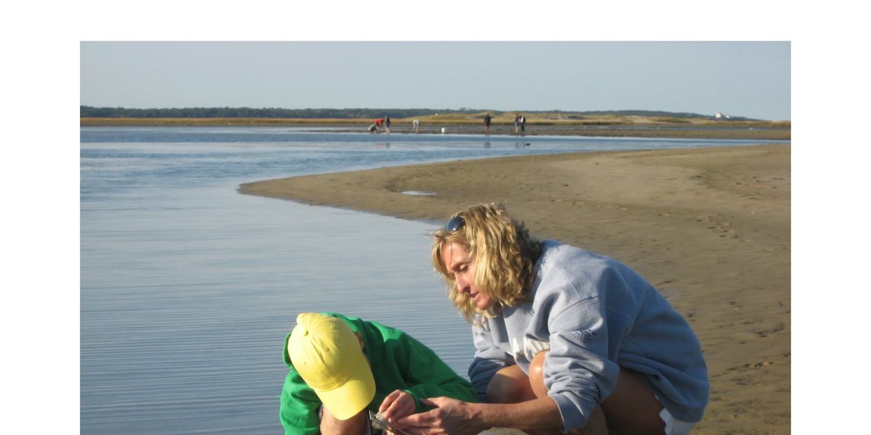 Mom and son measuring clams on the beach