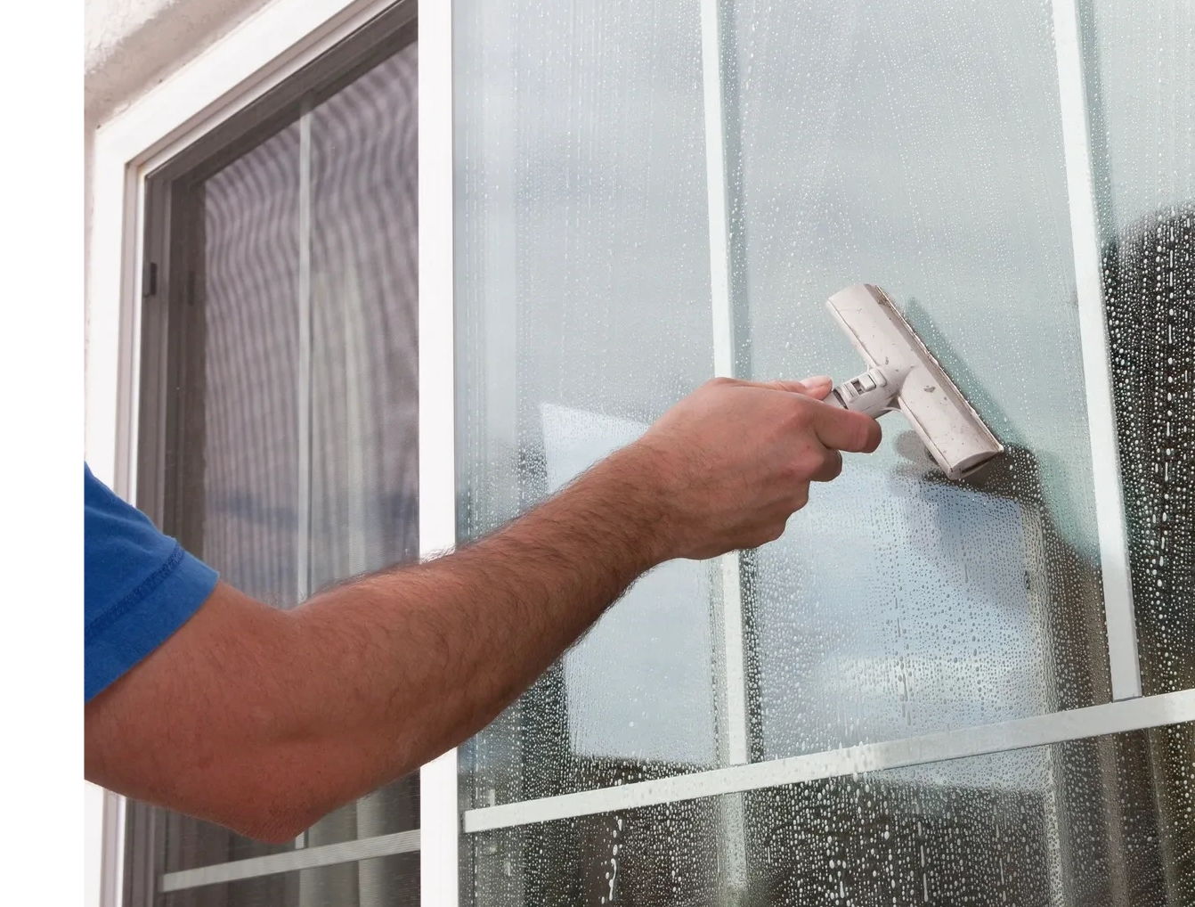 Person cleaning a window with a squeegee.
